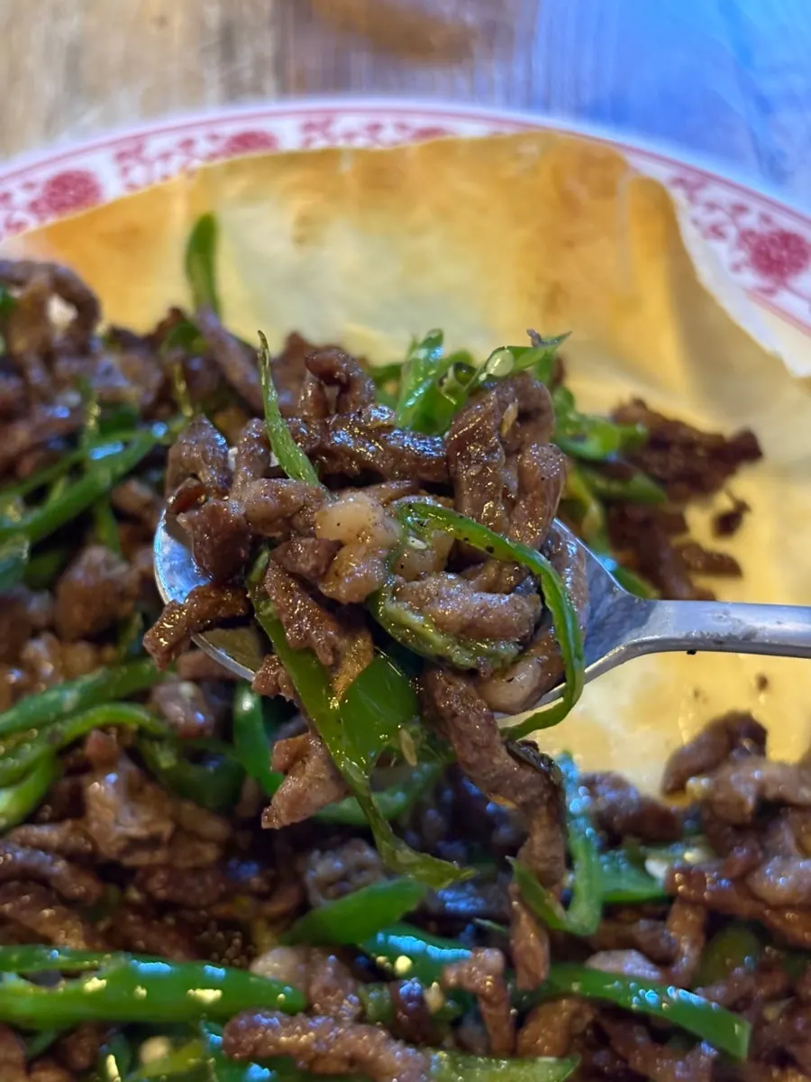 Stir-fried beef with peppers served on a tortilla plate
