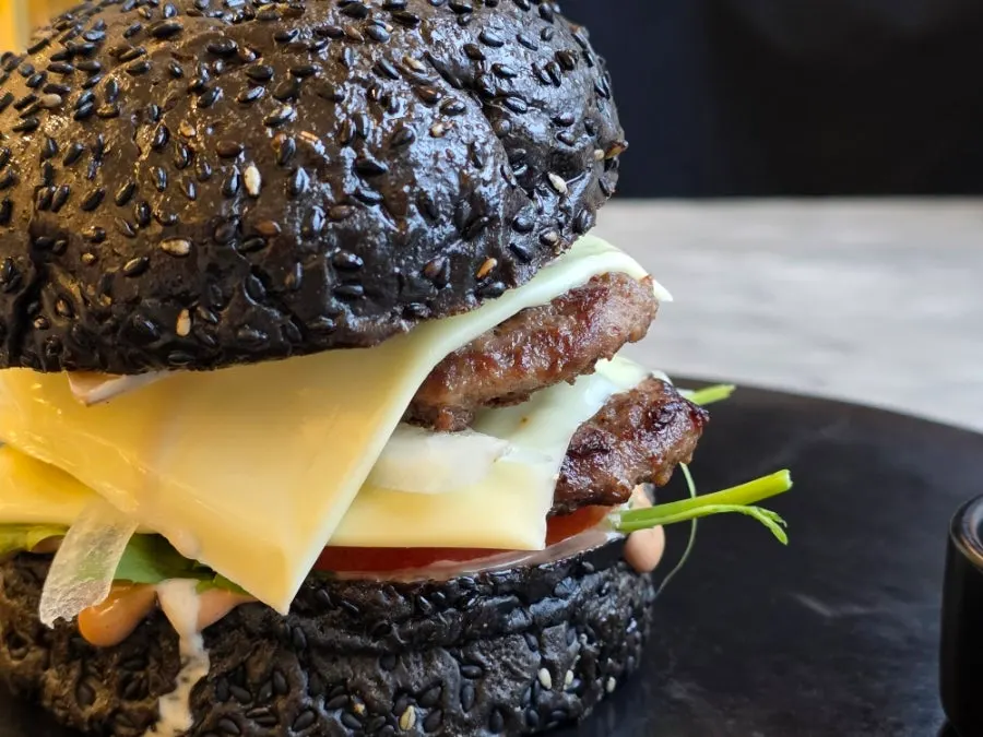 Side view of the gourmet black cheese burger