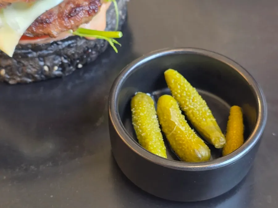 Pickles served alongside the burger