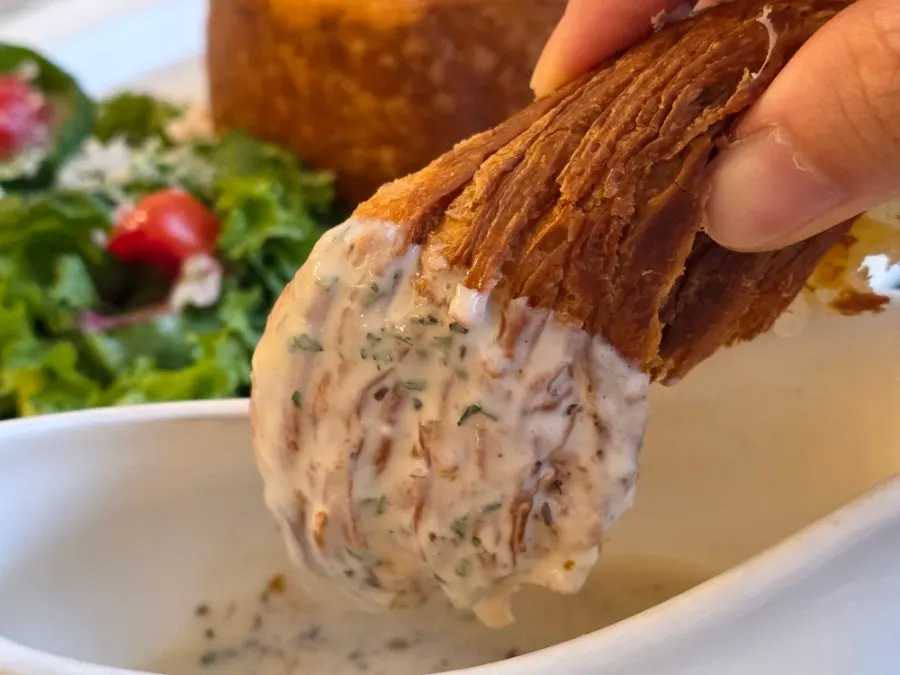 Dipping torn Mont Blanc pieces into the cream sauce