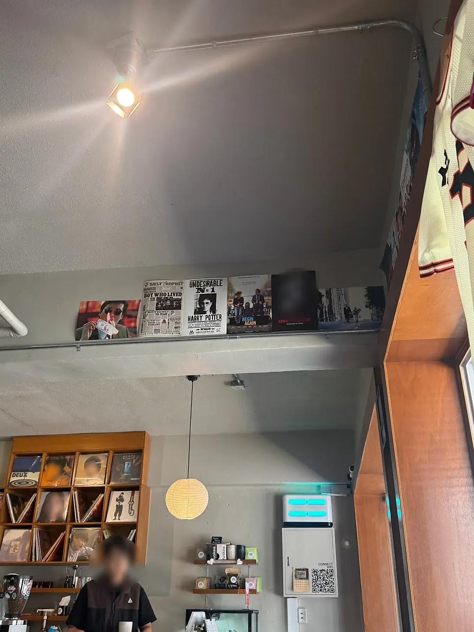 Café wall covered with movie posters and LP jackets