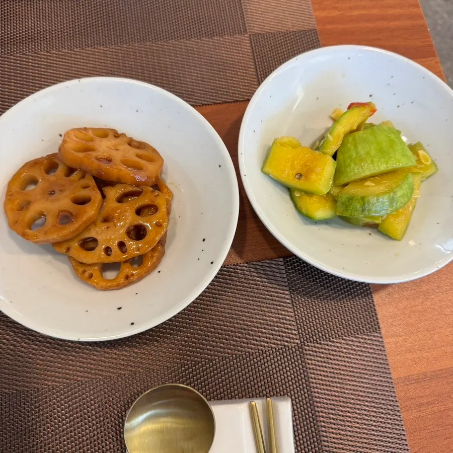 Side dishes of eggplant, lotus root, and kimchi