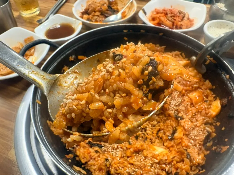 Grill plate nearly emptied of fried rice