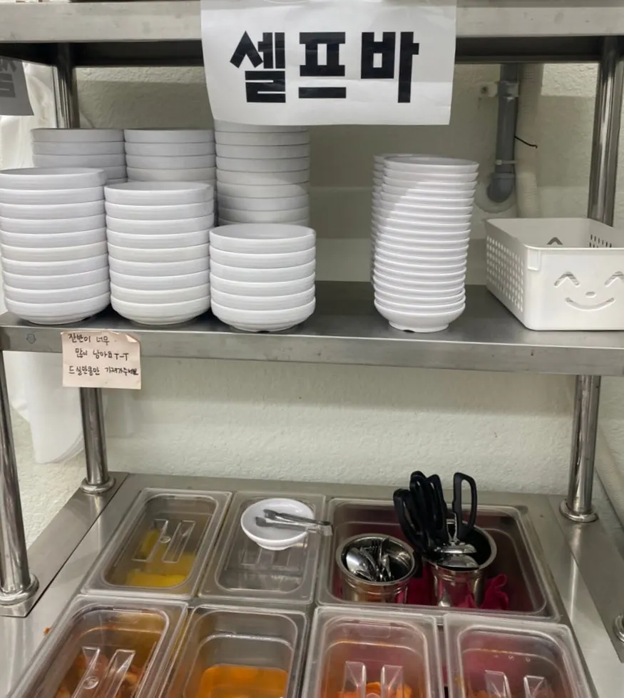 Self-serve bar with pickled radish, kimchi and spicy kimchi