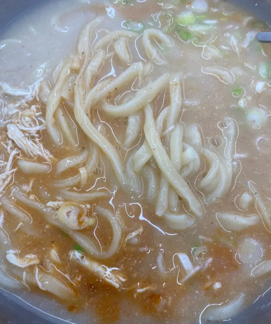 A ladle scooping up chicken broth