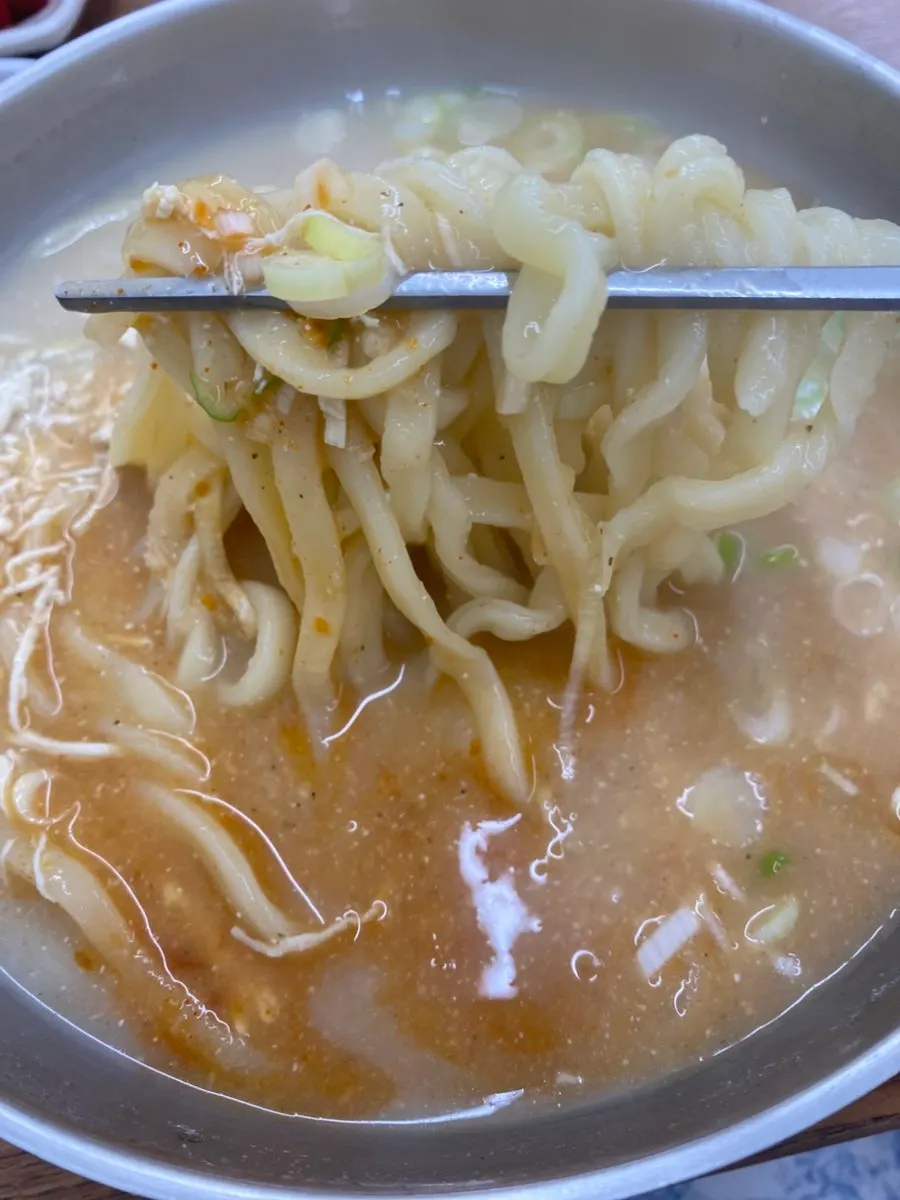 Chopsticks lifting house-made kalguksu noodles