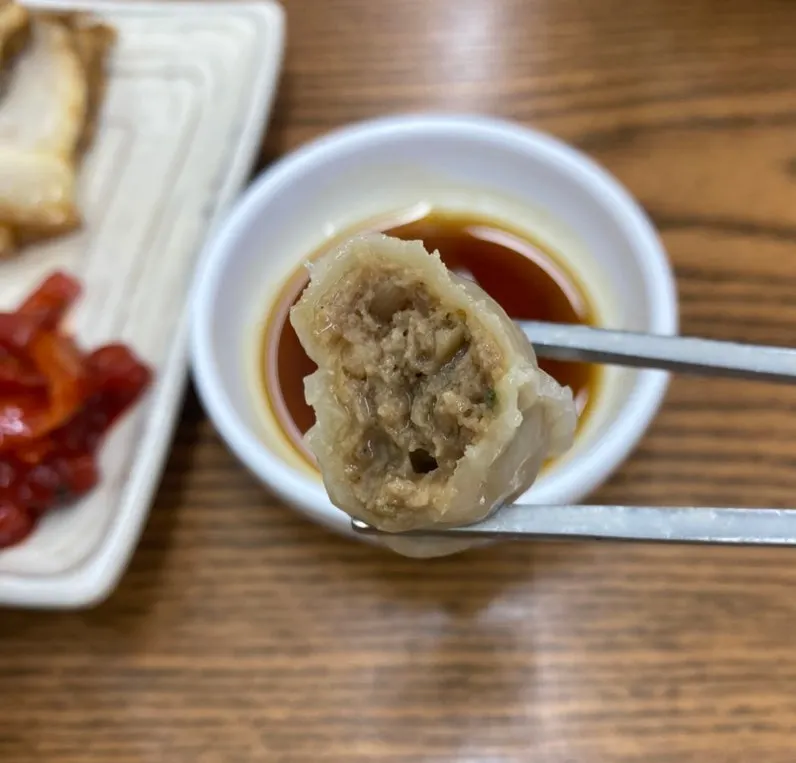 A galbi mandu cut in half showing the filling