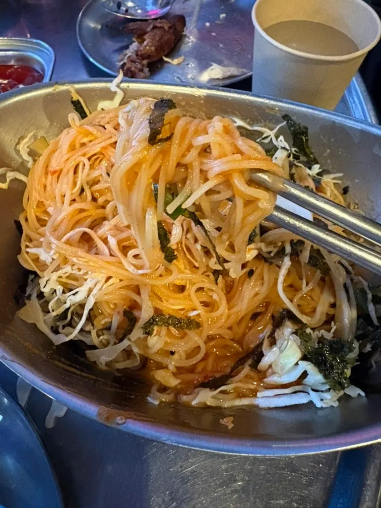 Bibim guksu topped with cabbage and seaweed