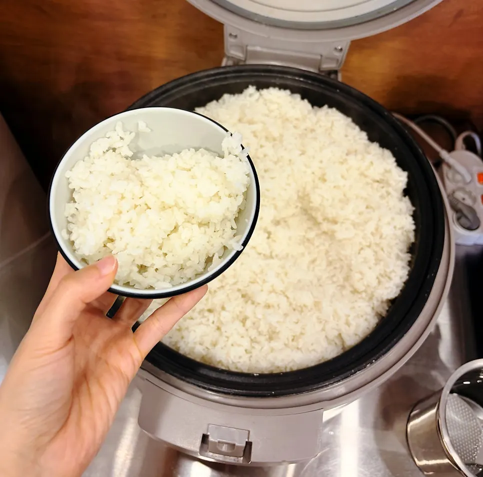 Rice being boiled in kalguksu broth to make dessert porridge