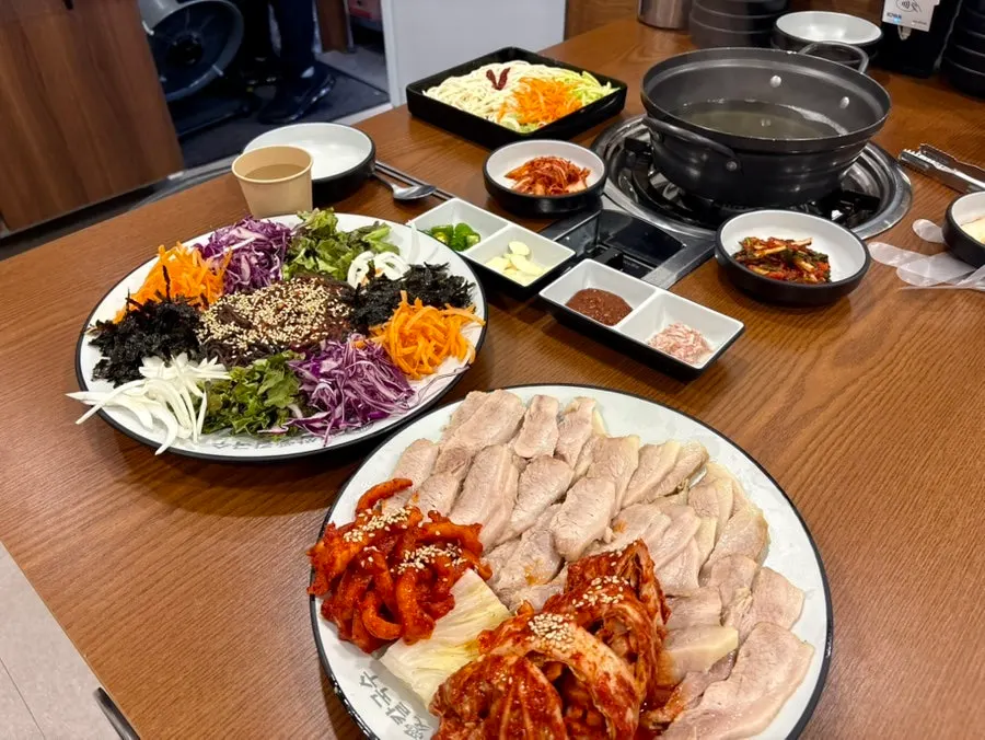 Bossam, kalguksu, and makguksu meal spread