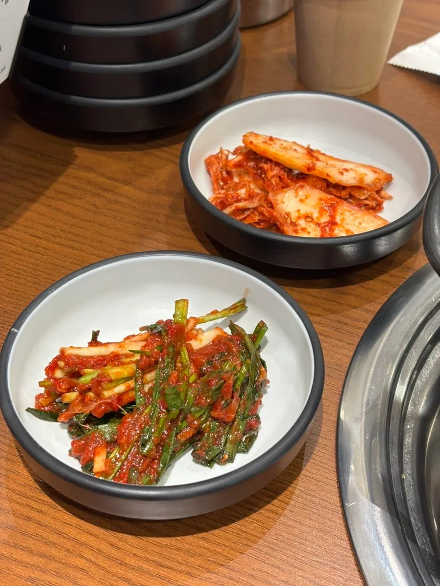 House-made green onion kimchi and geotjeori side dishes