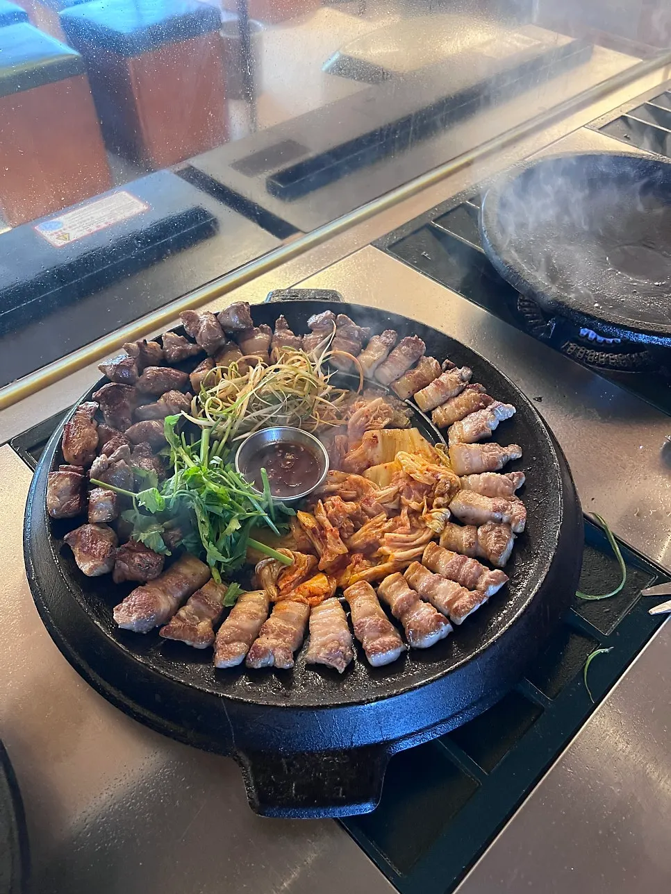 Cast-iron grill with kimchi and minari