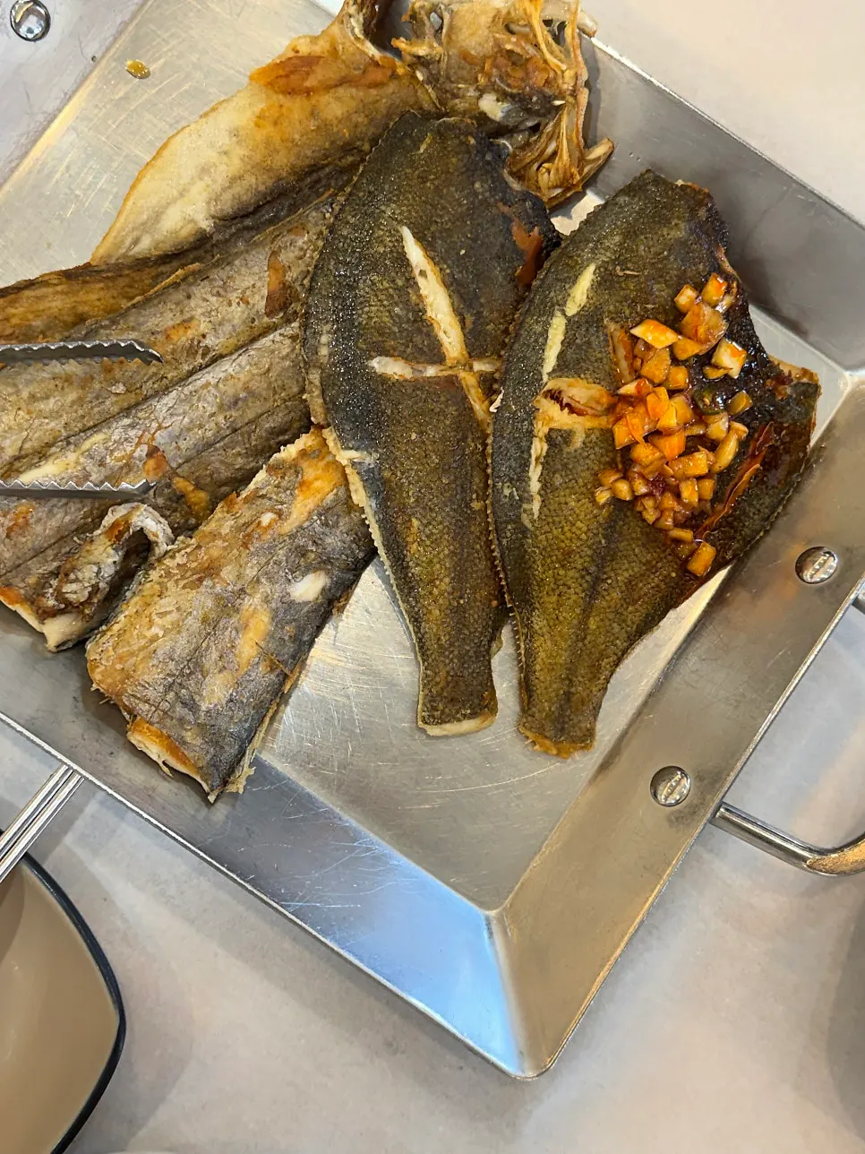 Flaked grilled fish with a spoonful of rice