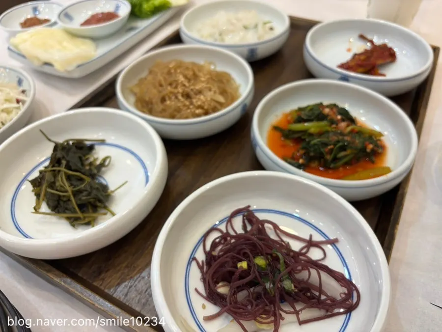Side dish spread with namul, japchae, and kimchi