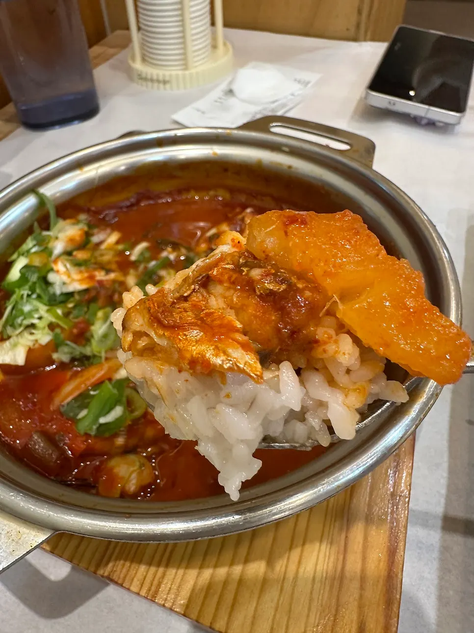 A spoonful of rice topped with cutlassfish flesh and braised radish
