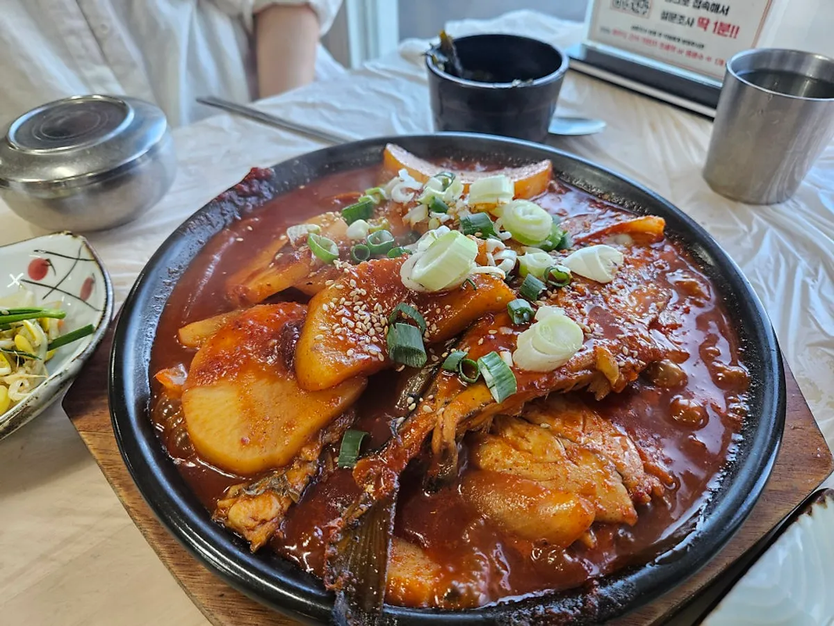 A bowl of braise with mackerel and radish