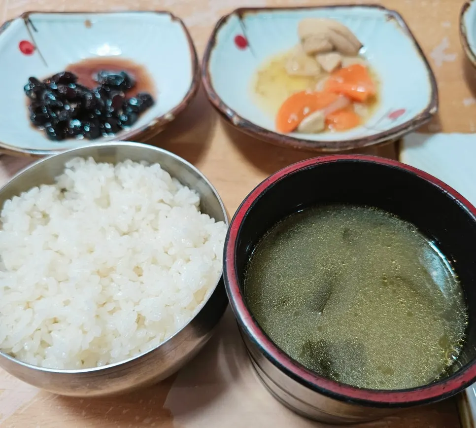 A child eating rice mixed with seaweed soup