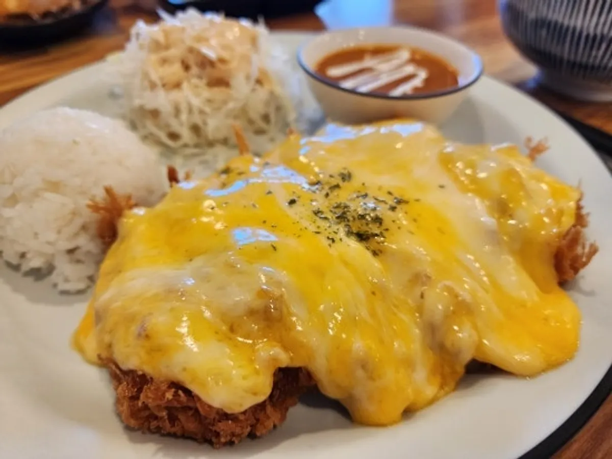 Pork loin cutlet generously topped with cheese