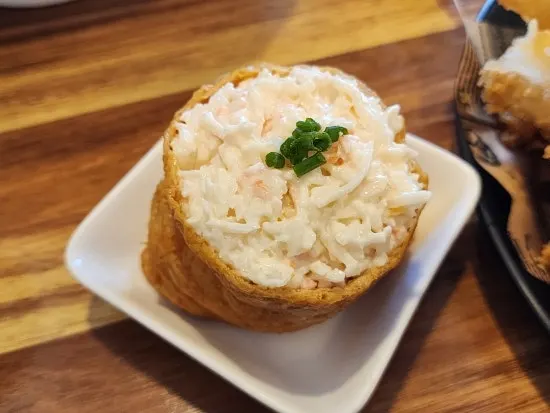 Inari sushi topped with crab meat