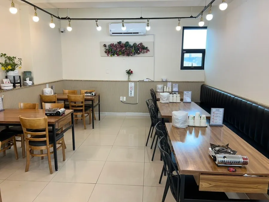 Full view of the dining hall with 4-person and 8-person tables