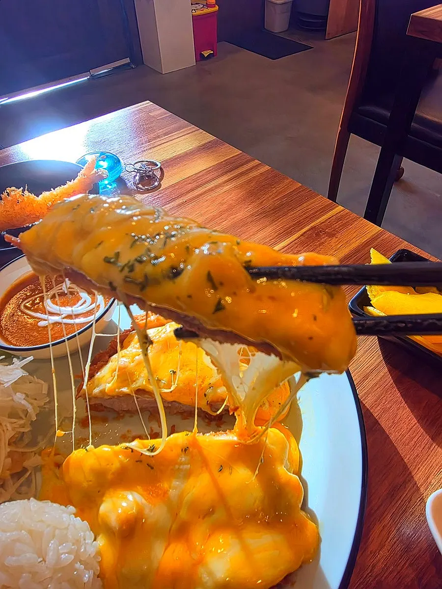 Plate of cheese pork cutlet covered in melted cheese