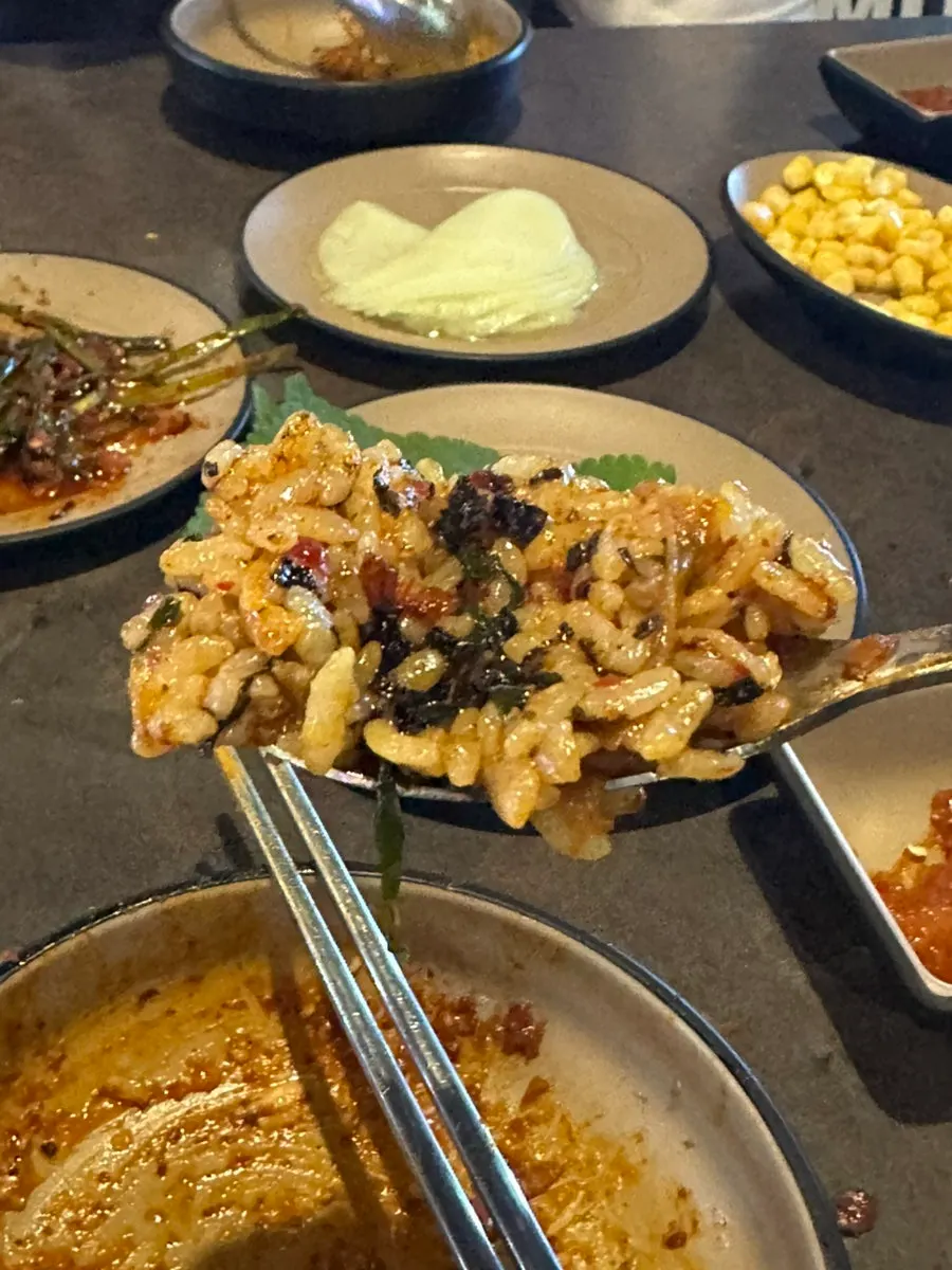 Fried rice spread out on the hot plate to cook