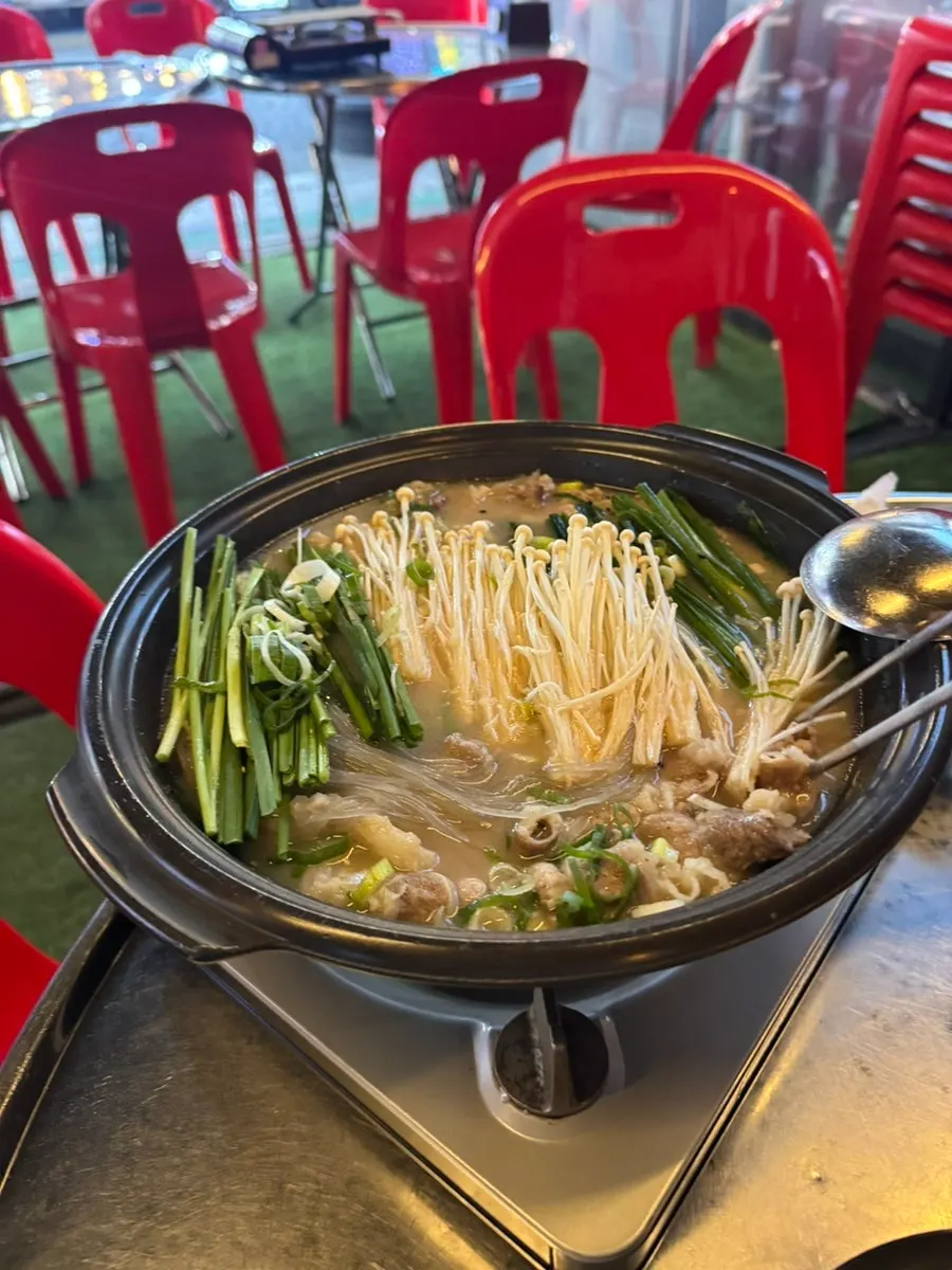 Hot pot filled with tendon, chadolbagi beef, and enoki mushrooms