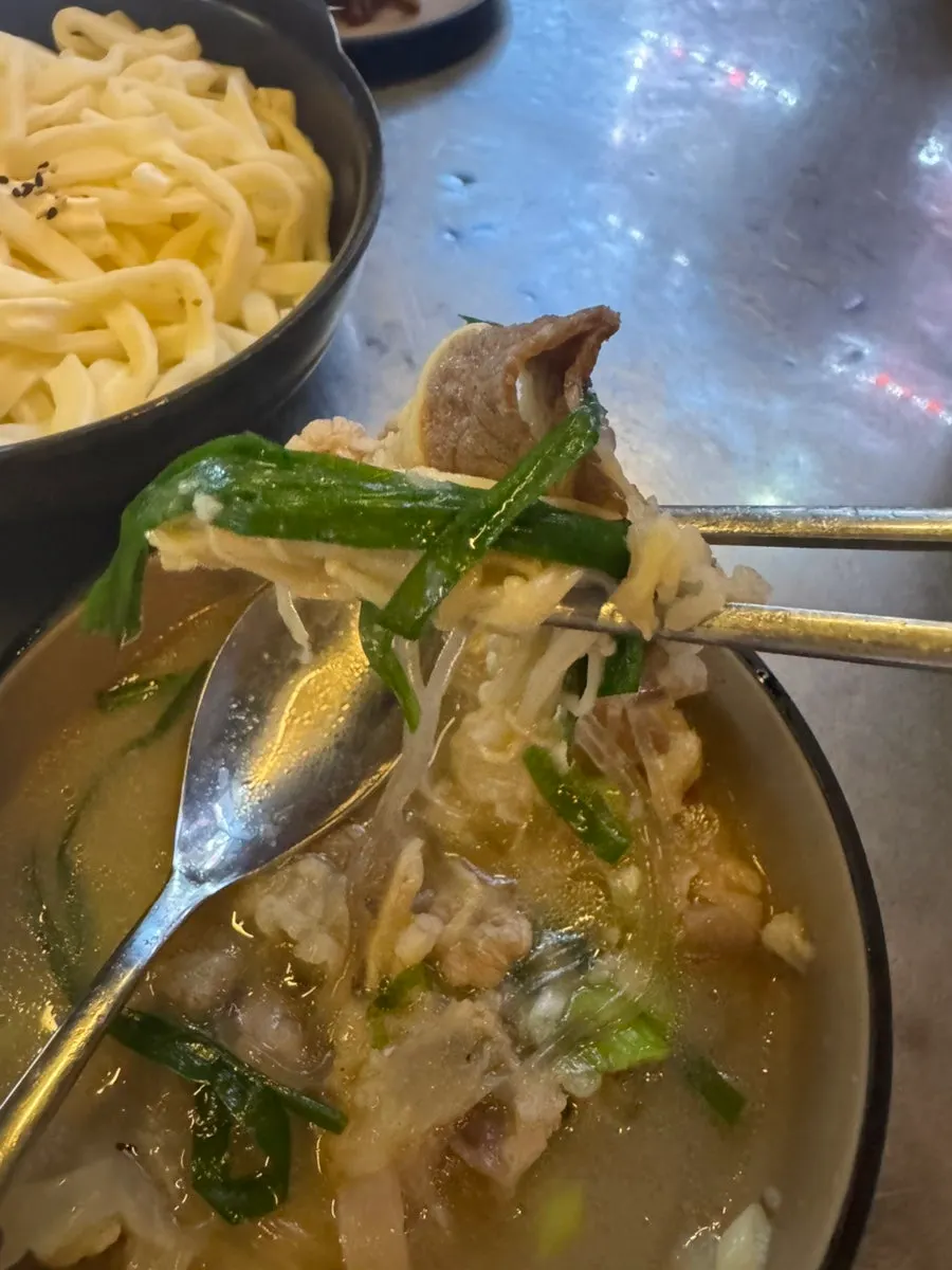 A spoonful of cooked chives and chadolbagi beef