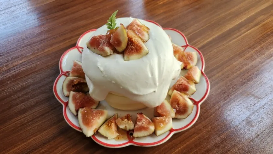Two-layer fig soufflé topped with fresh cream and seasonal figs