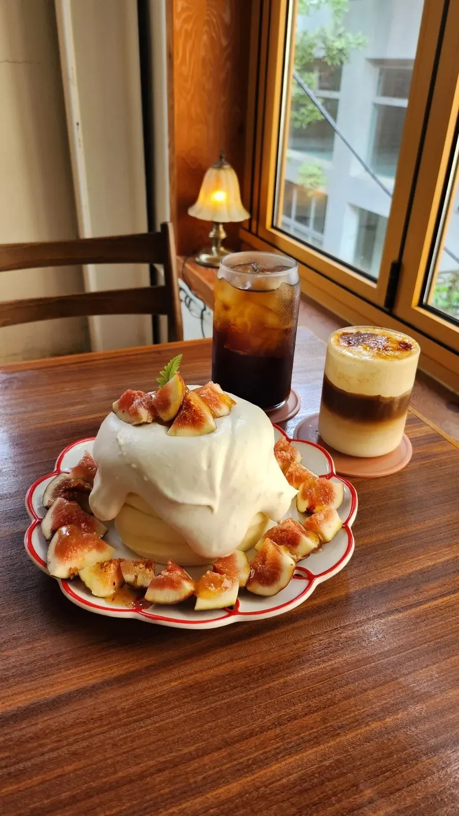 Soufflé and coffee set by the window with a Seoul Forest view
