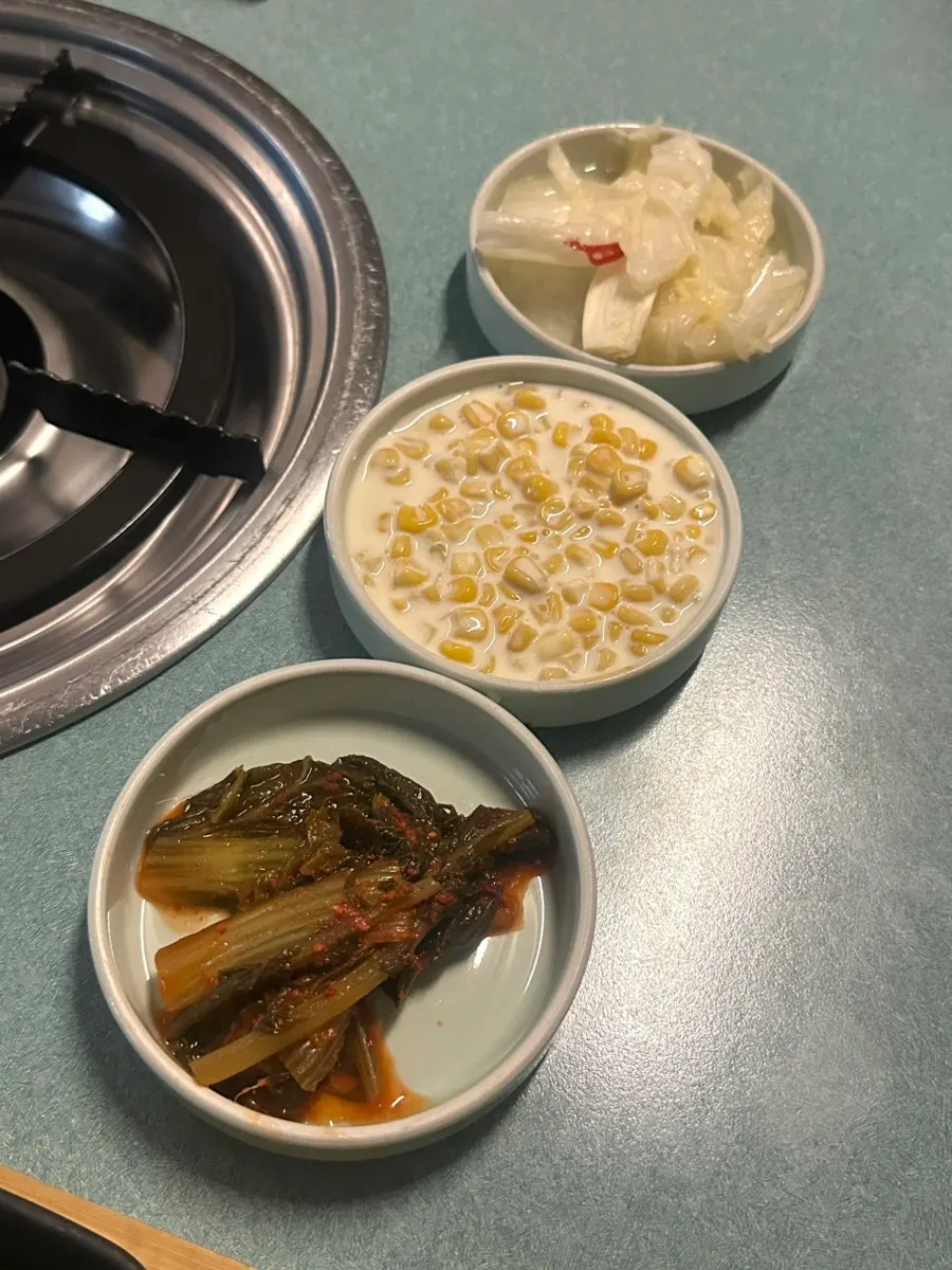 Basic side dishes: yeolmu kimchi, corn salad, and baek-kimchi