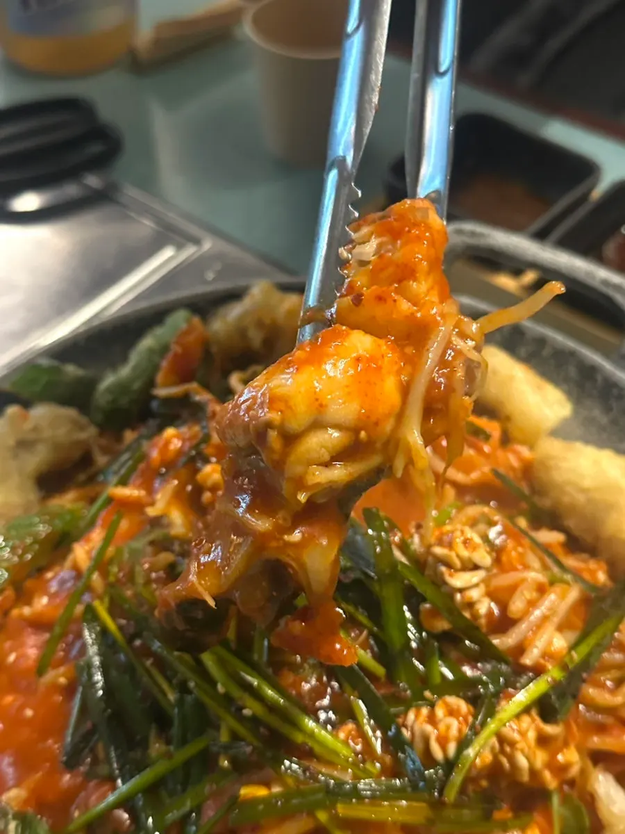 Plump monkfish meat picked up with chives