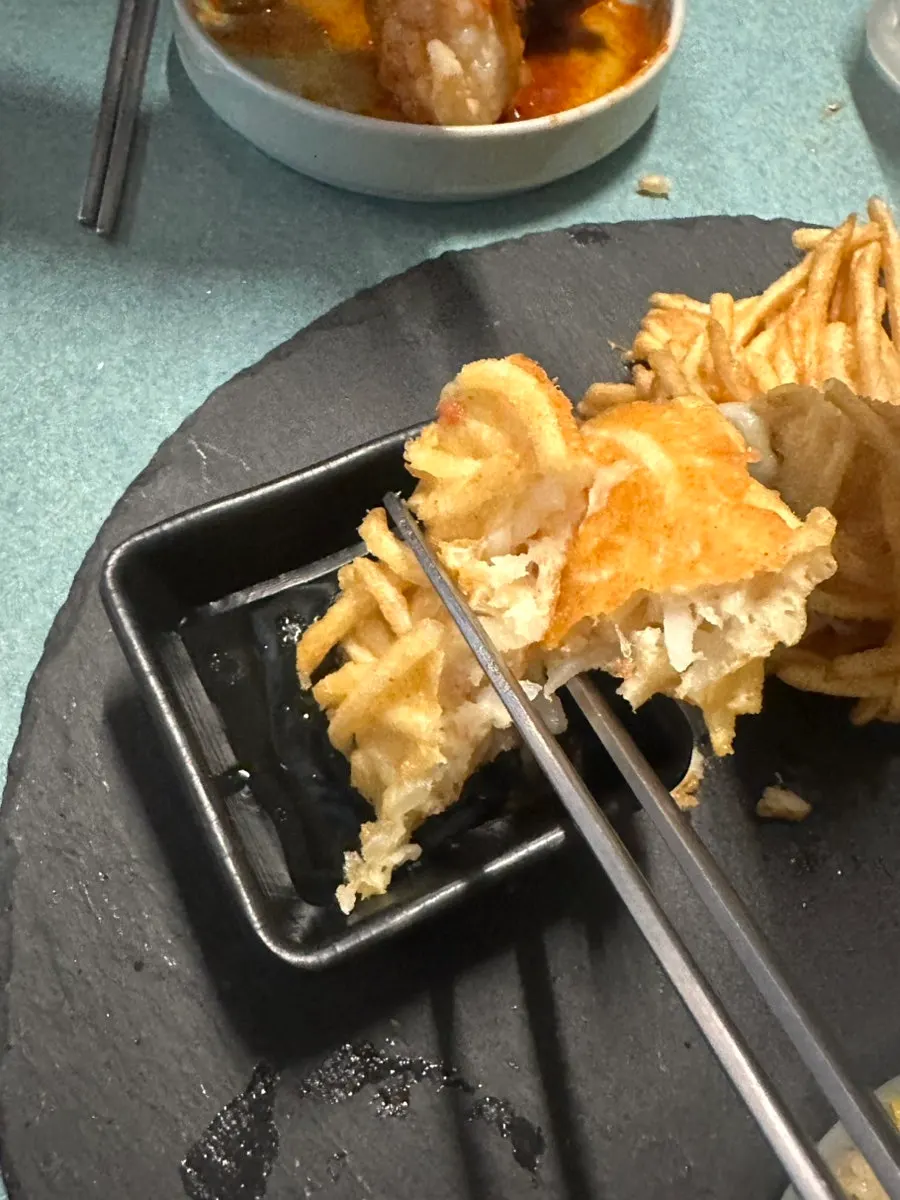 A piece of cheese potato pancake with cheese stretching