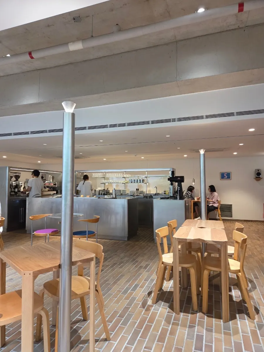 T Coffee's main hall with a steel bar counter