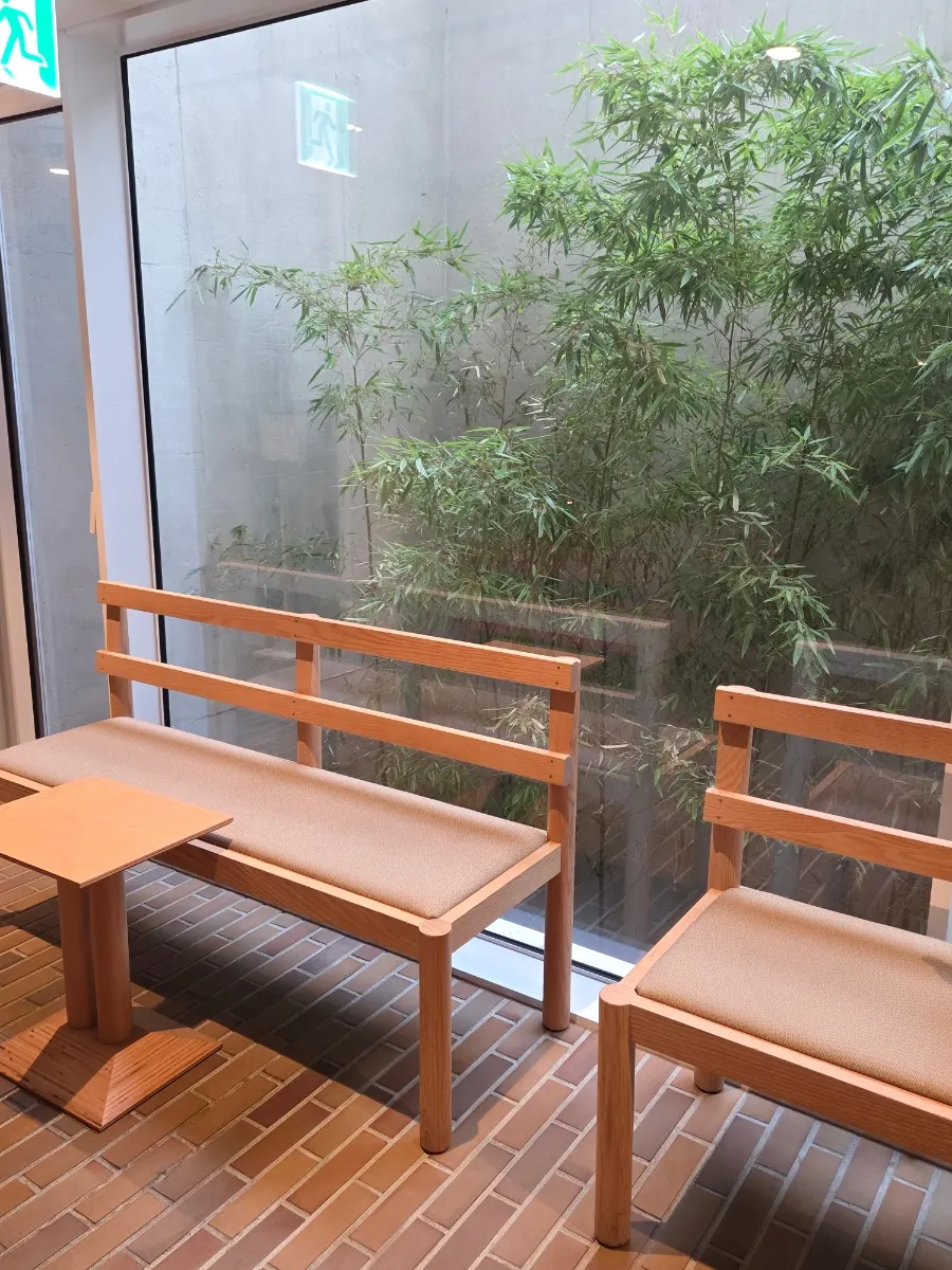 Floor-to-ceiling window seat overlooking a bamboo garden