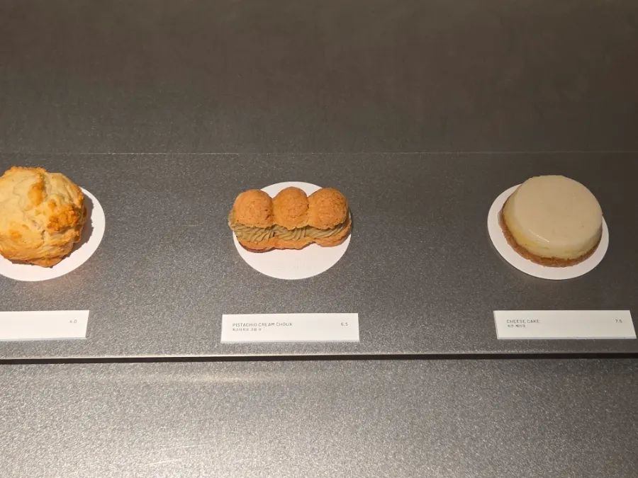 Pistachio cream choux and cheesecake on display
