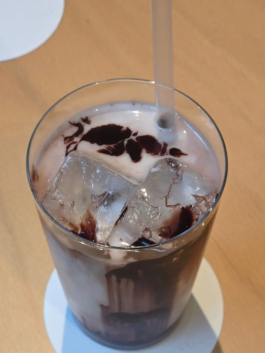 Iced chocolate latte with a chocolate swirl design