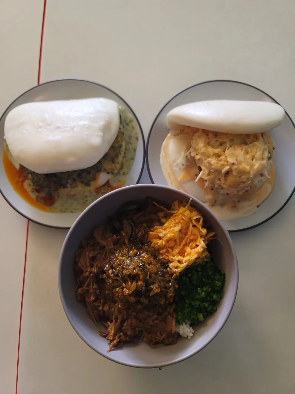 Bao and braised pork rice bowl spread