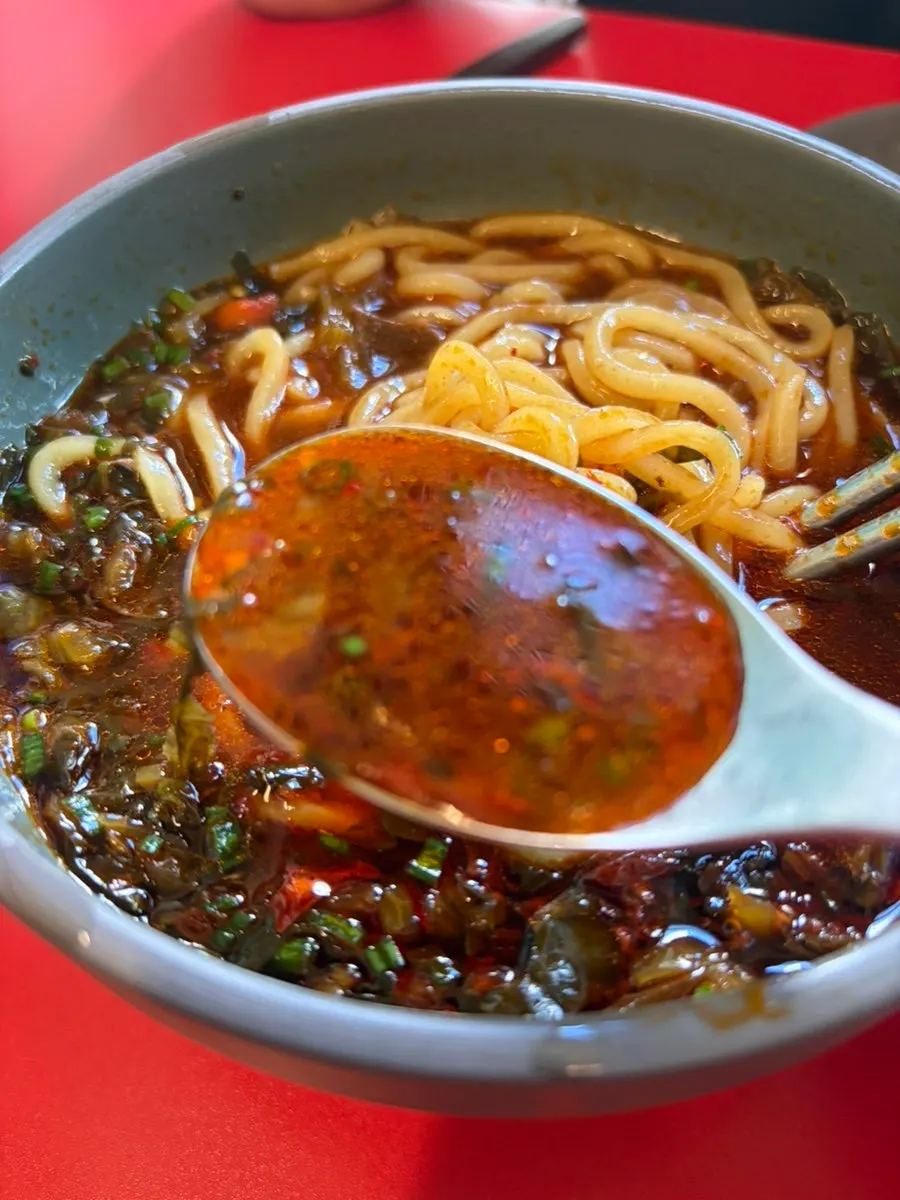 Beef noodle soup broth with chili oil and spices