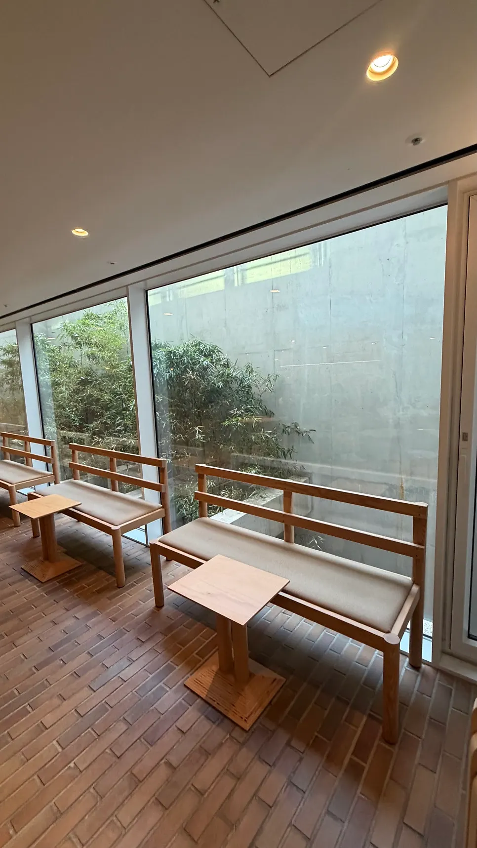 Seating with a view of the green landscaping through the window wall