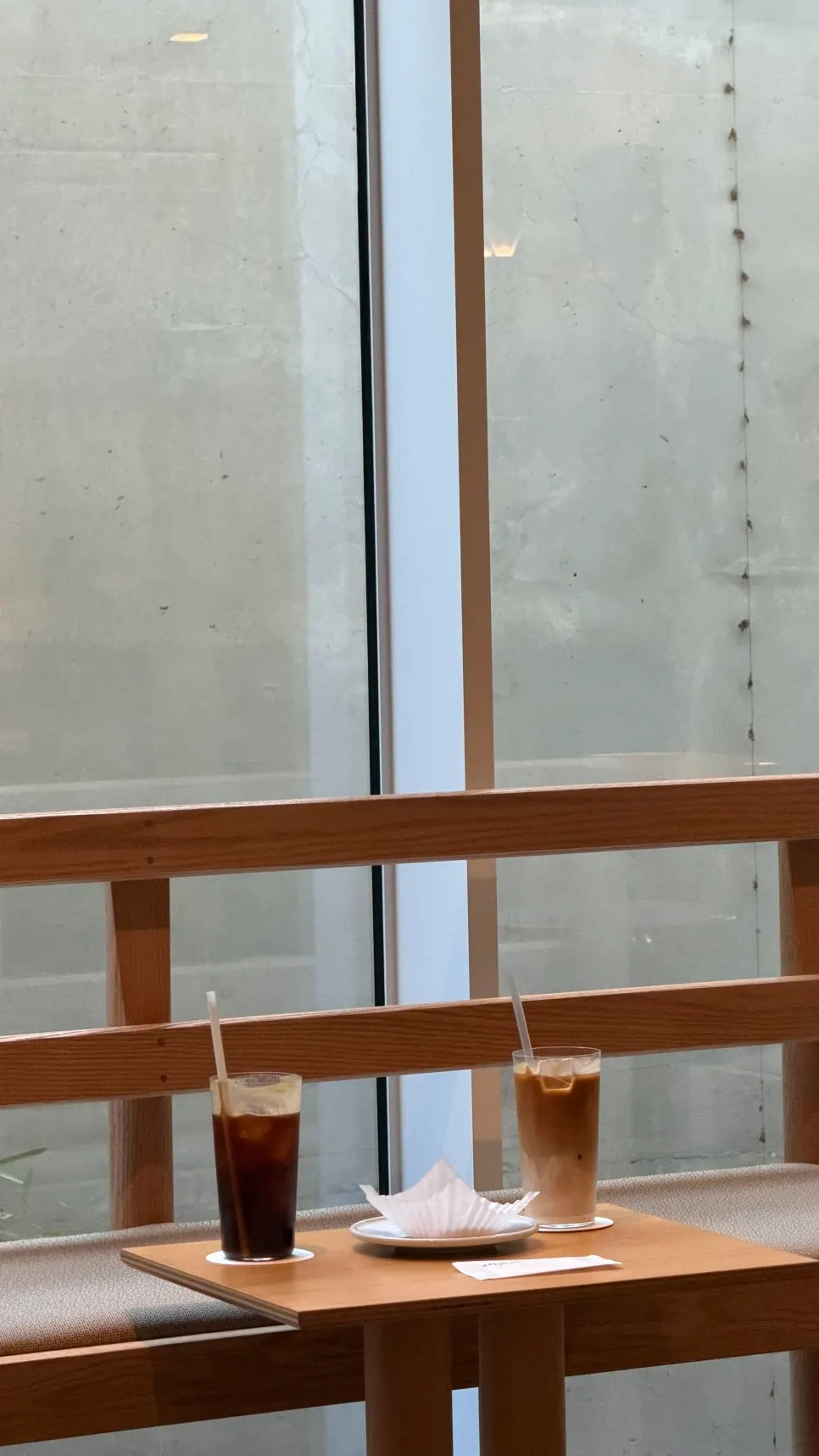 Long wooden bench and table by the window