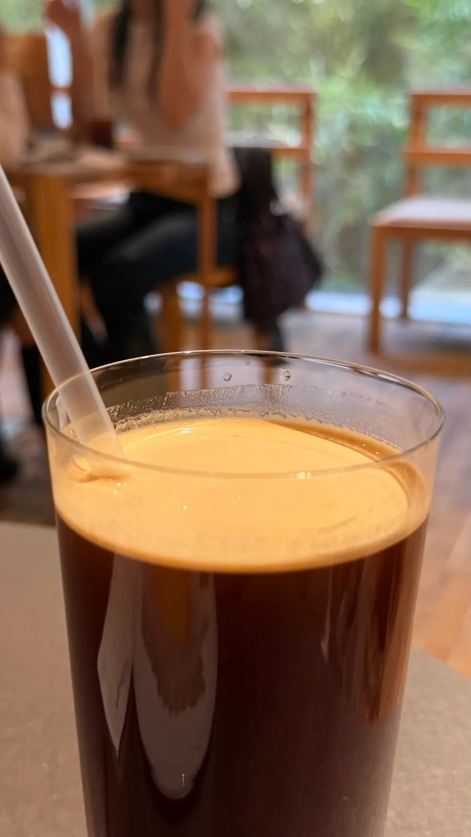 Iced americano with a thin layer of crema on top