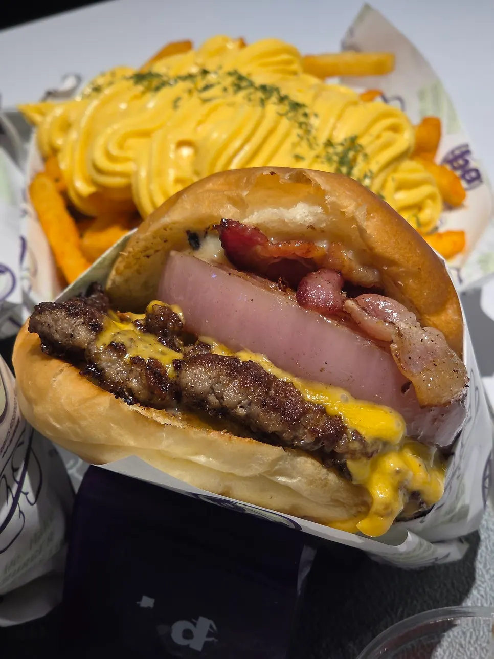 Close-up of the double cheese burger with bacon added