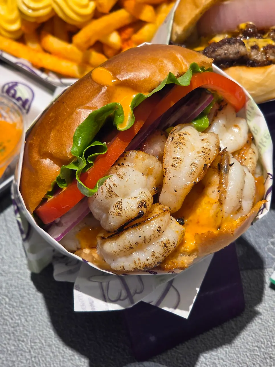 Cross-section of the shrimp burger packed with char-grilled whole shrimp