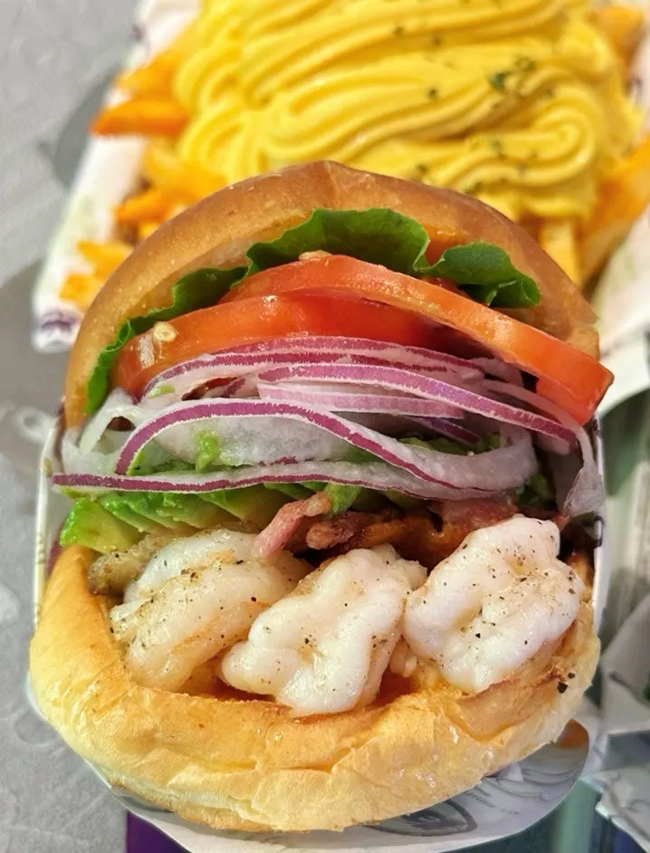 A spread of ordered shrimp burgers and fries