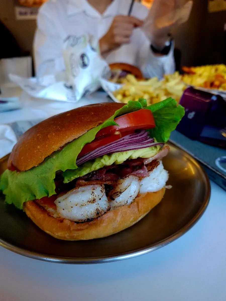 Cross-section of the shrimp burger showing avocado and bacon