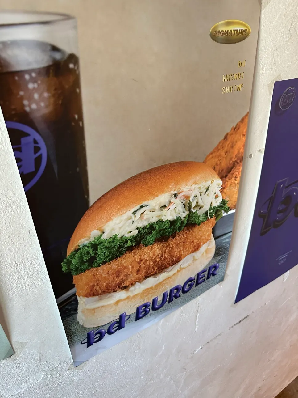 Handmade burger photos displayed on the staircase wall