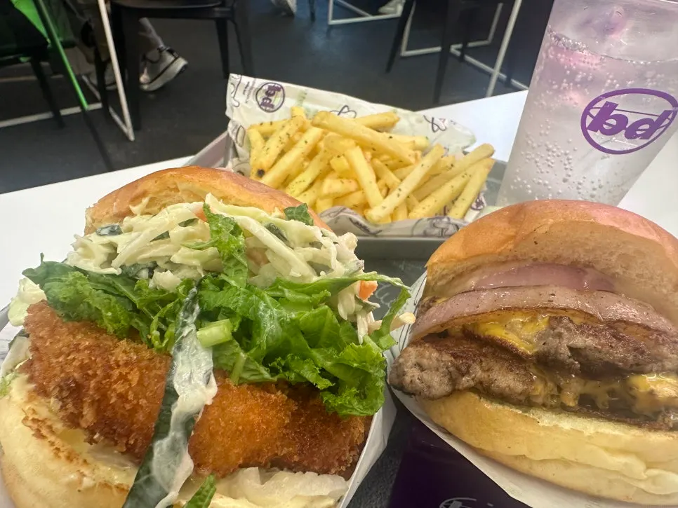 Wasabi shrimp and double cheese burger served on the table