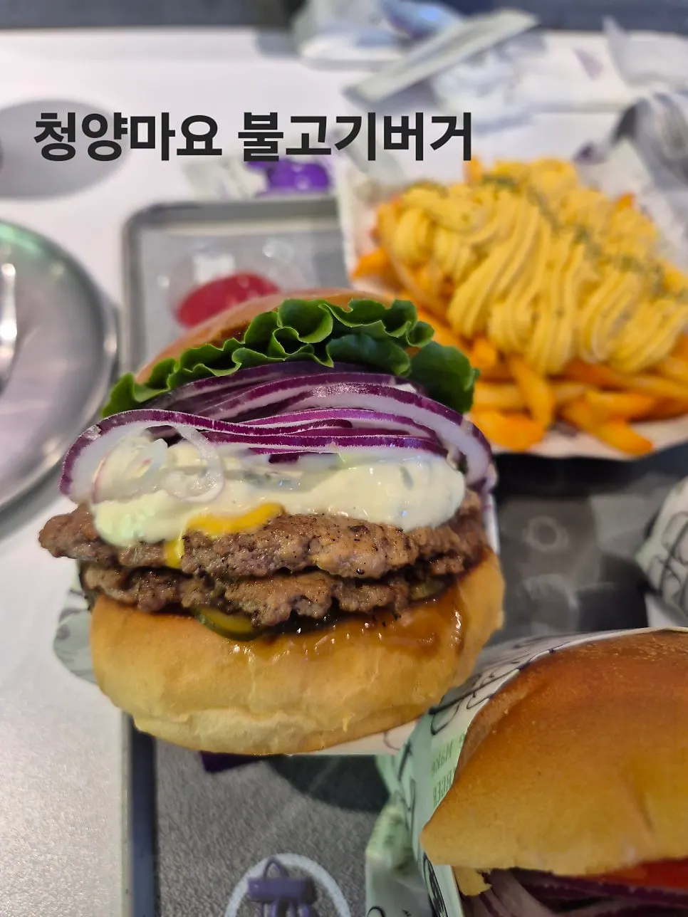 Big bite taken out of a bd Burger Seongsu burger