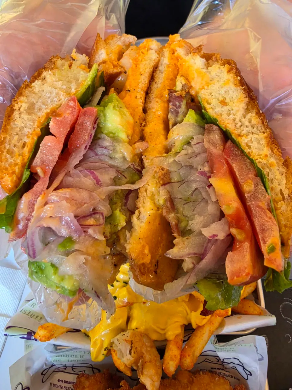 Burger topped with shrimp and avocado
